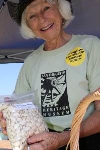 Hildegarde, a volunteer with the San Dieguito Heritage Museum, selling dried lima beans to attendees of the faire. Photo by Christopher. 